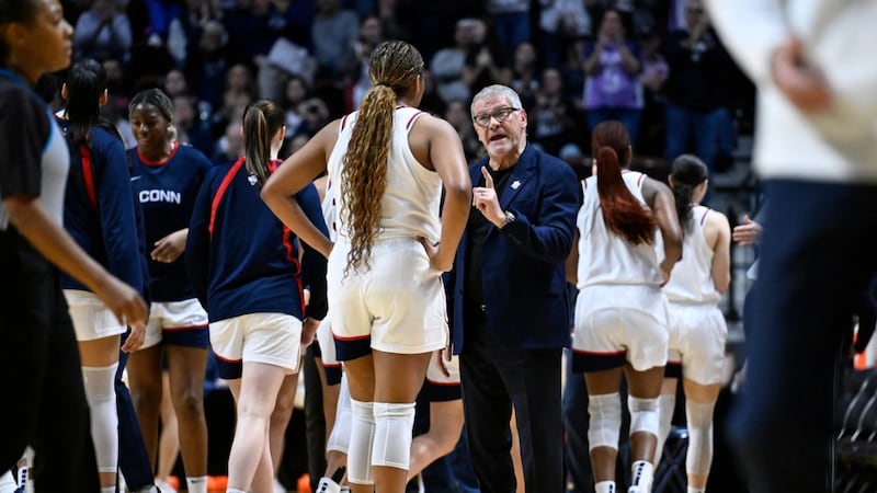 UConn head coach Geno Auriemma talks with forward Sarah Strong during first half of an NCAA...