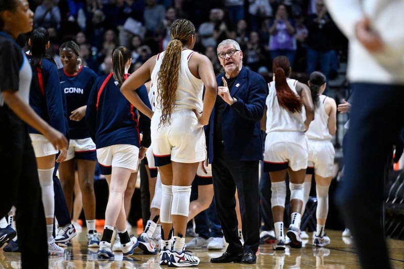 UConn head coach Geno Auriemma talks with forward Sarah Strong during first half of an NCAA...