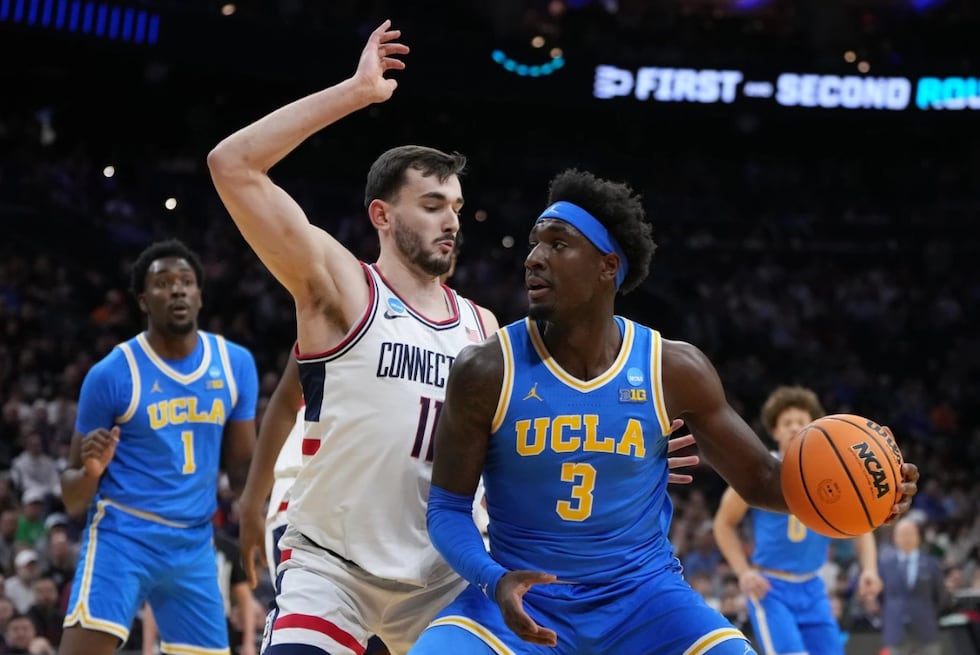 UCLA's Eric Dailey Jr., right, tries to get past UConn's Alex Karaban during the first half in...