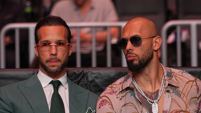 FILE - Andrew Tate, right, and his brother Tristan arrive an event, April 11, 2026, in Miami....