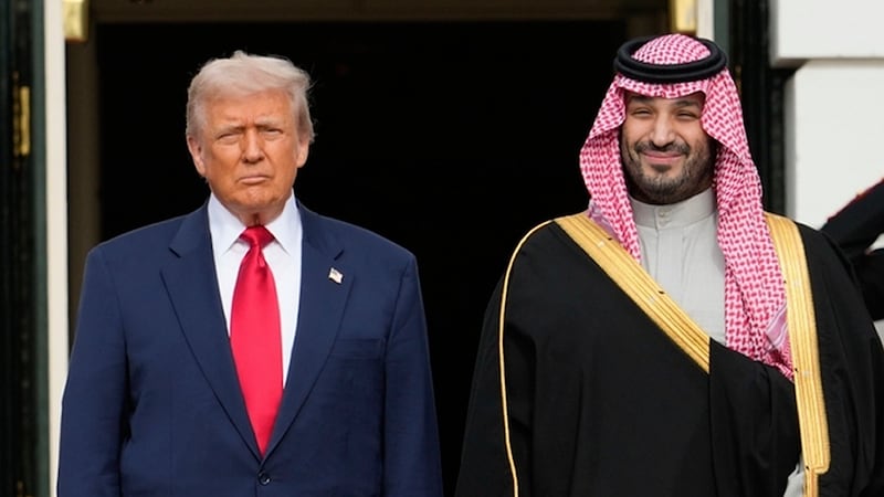 FILE - President Donald Trump stands with Saudi Arabia's Crown Prince Mohammed bin Salman on...