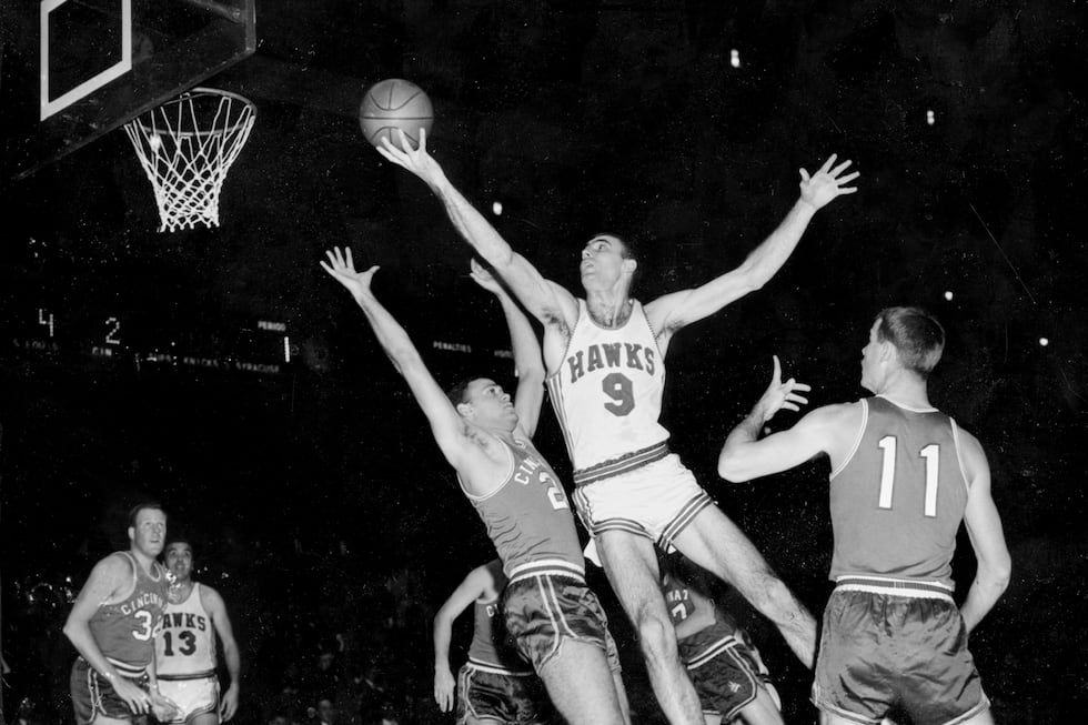 FILE - FILE - In this Dec. 10, 1957, file photo, Bob Pettit, of the St. Louis Hawks, leaps to...