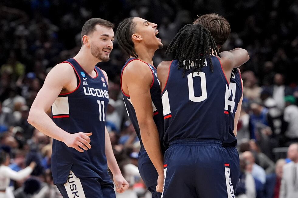 UConn guard Braylon Mullins, right, celebrates his game winning basket with guard Malachi...