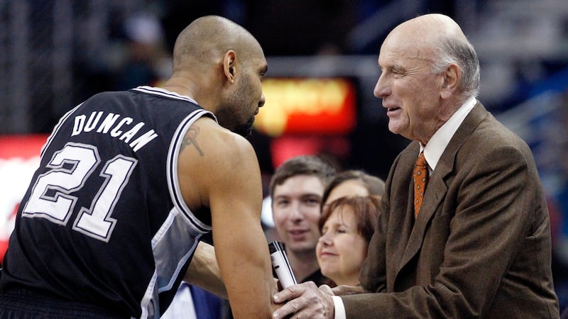 FILE - San Antonio Spurs power forward Tim Duncan (21) shakes hands with former NBA player Bob...