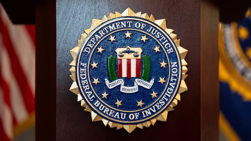 FILE - An FBI seal is displayed on a podium before a news conference at the field office in...